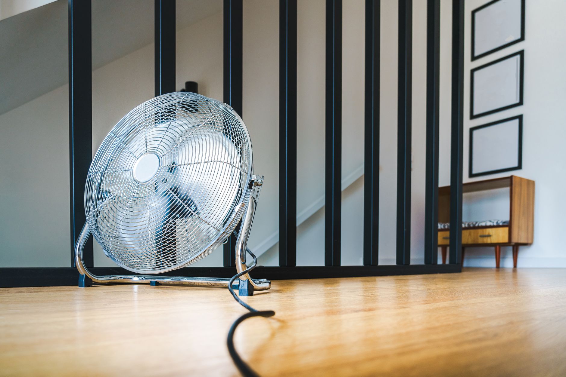 Person feeling uncomfortable heat in a Dubai room with air conditioning not working