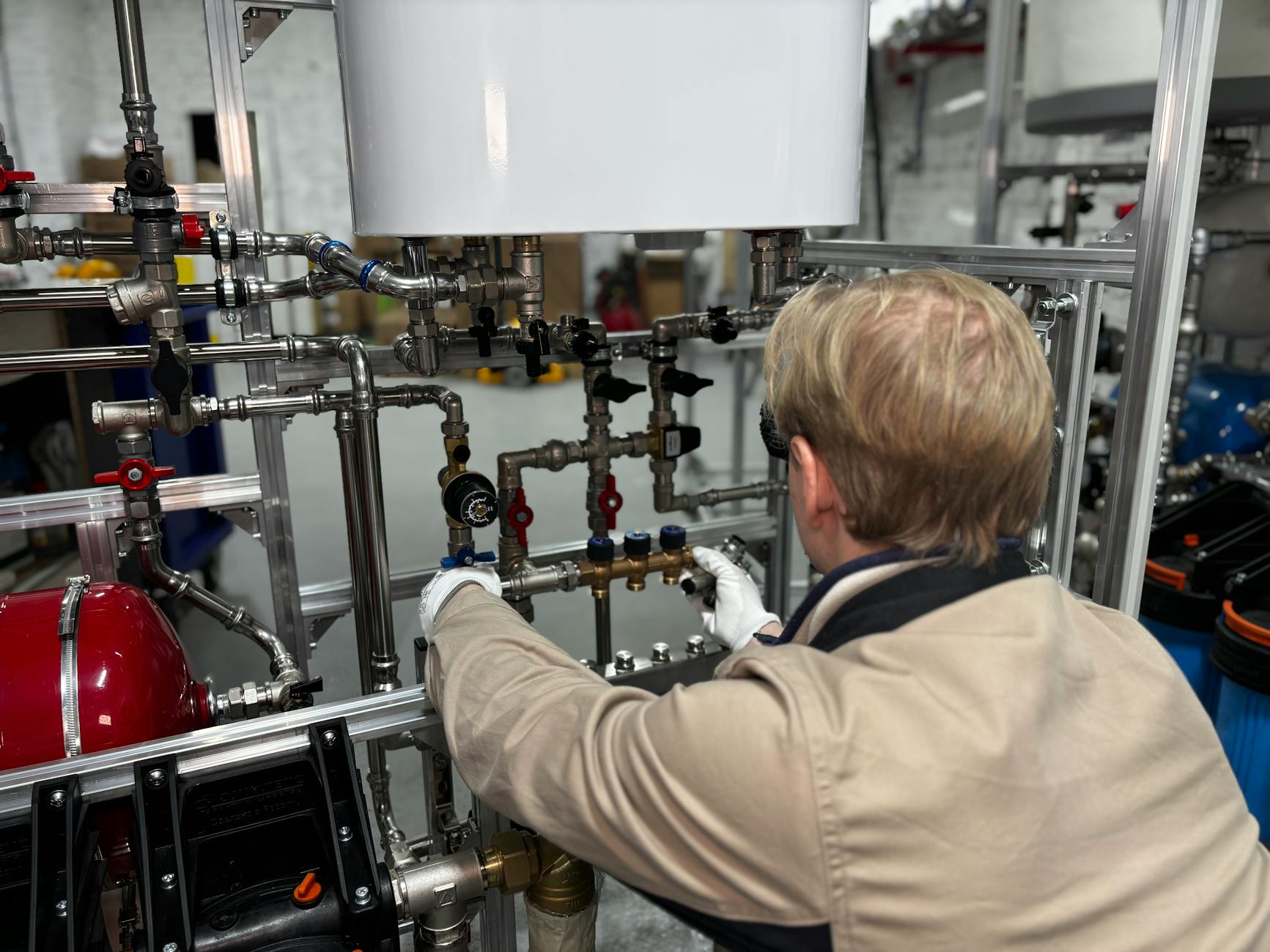 Professional plumber inspecting under-sink plumbing fixtures in Dubai